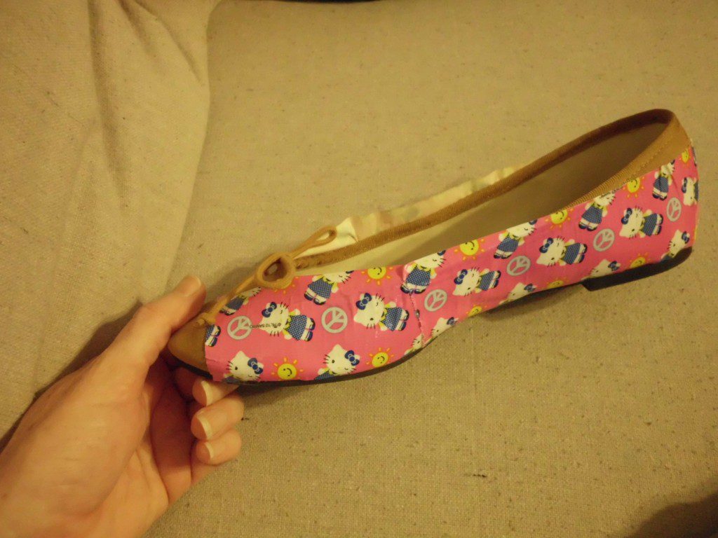 How to Give Shoes a Makeover with Duct Tape applying tape to shoe