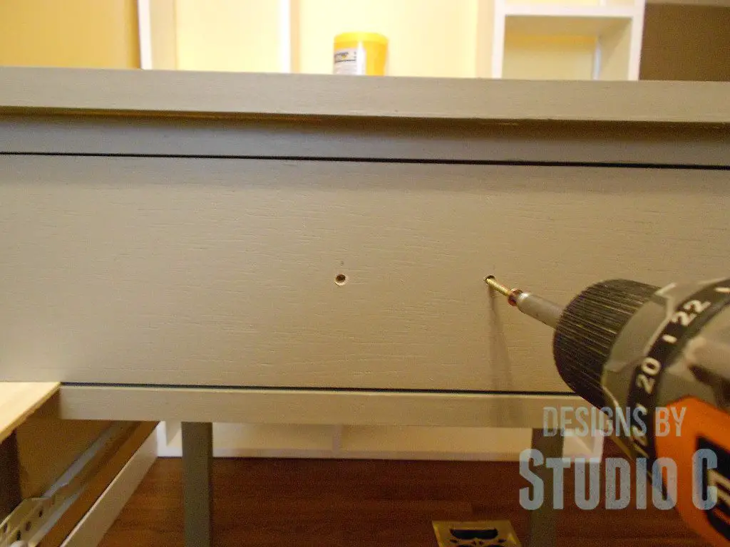 Easy Way to Install Drawer Fronts driving screws through front 