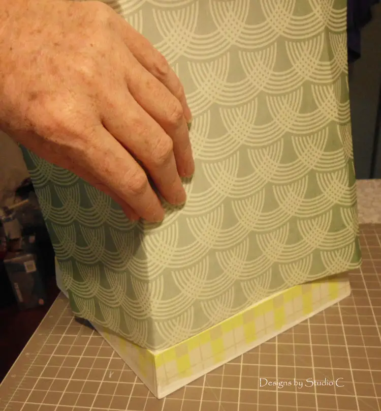 How to Give an Old Wastebasket a Makeover apply scrapbook paper to the outside