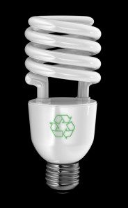 Energy saving light bulb with recycling symbol over black