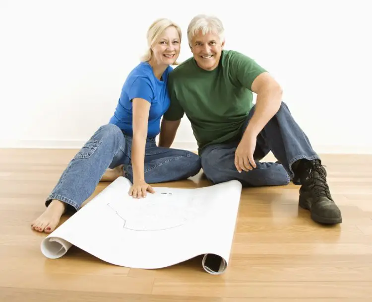 wooden floor options Man and woman with blueprints.