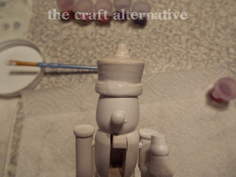DIY Painted Nutcrackers with Glitter Hats apply Mod Podge to the hats