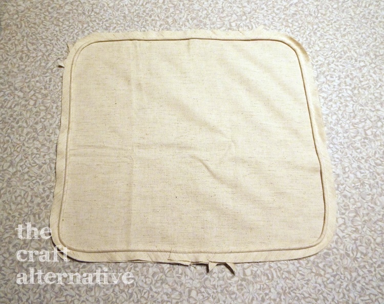 Make a Pillow with a Needlepoint Piece sew piping to the back piece