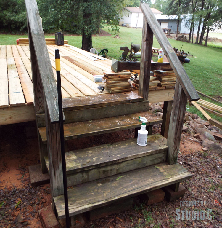 cleaning old treated wood with Spray Nine in the process of scrubbing