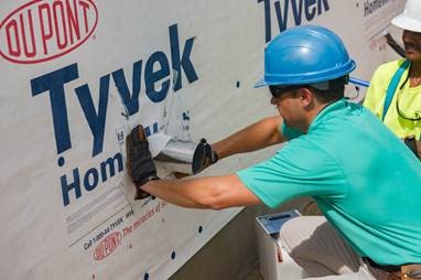 weatherization for the home worker applying Tyvek close up