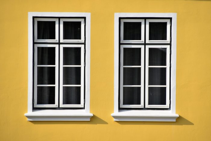 window buying tips white frames on yellow exterior