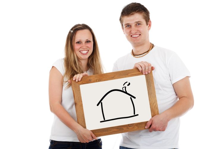 5 things before moving couple holding drawing of house