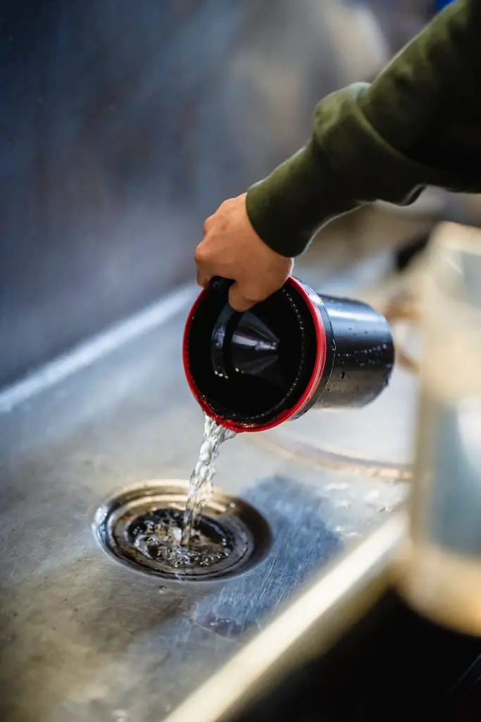 parts of a kitchen sink drain pouring water 
