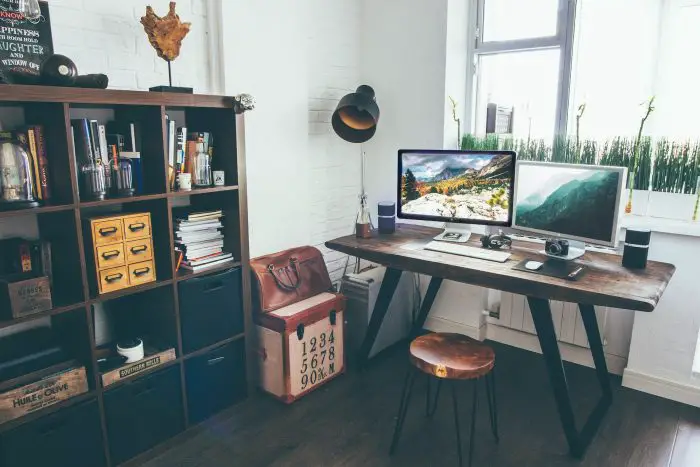 pros cons open floor plan cluttered desk area with bookcase