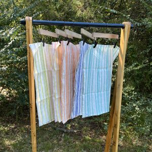 handcrafted linen dish towels on hanging rack