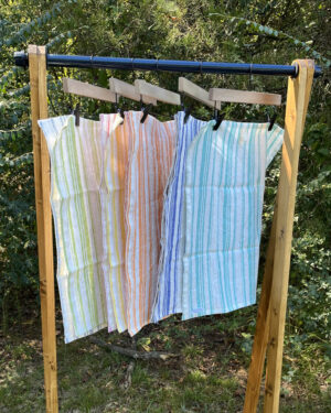 handcrafted linen dish towels on hanging rack