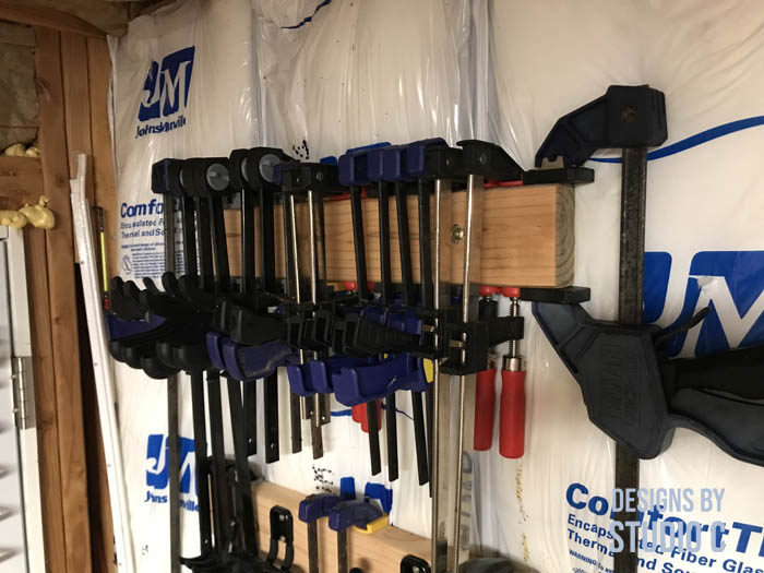 DIY clamp organizer neatly lined clamps on board