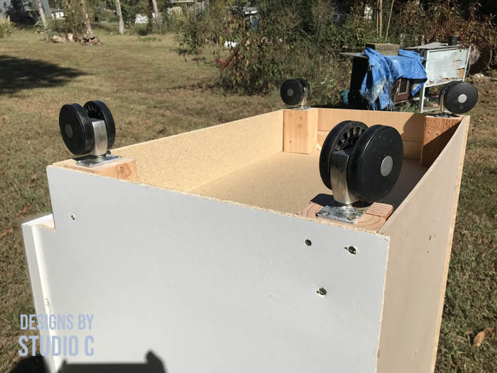 how to make a work table out of a base cabinet add supports and install casters
