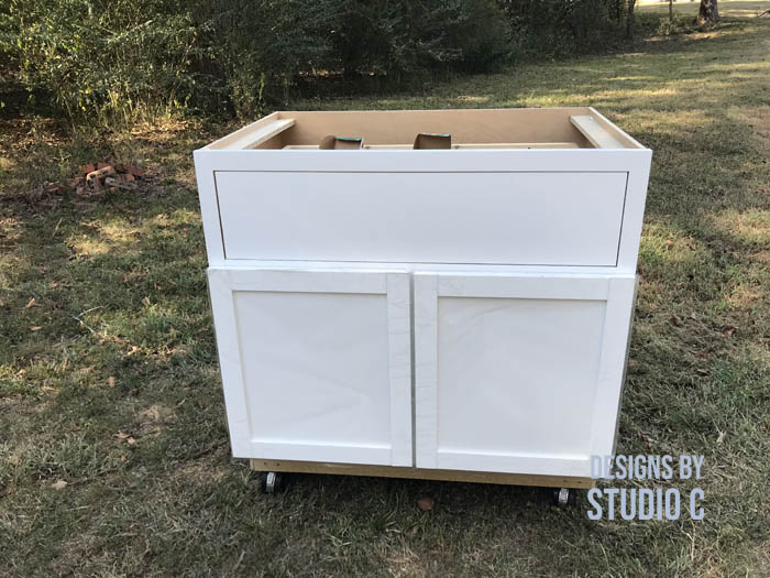how to make a work table out of a base cabinet using apron as drawer front
