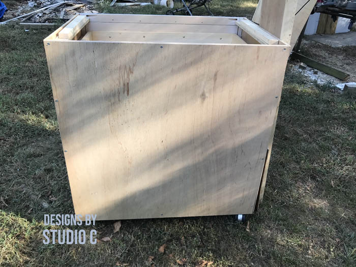 how to make a work table out of a base cabinet added plywood to back