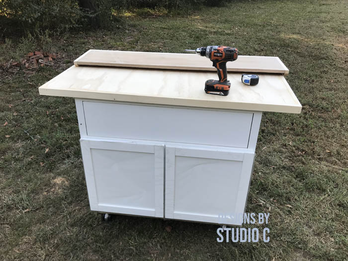 how to make a work table out of a base cabinet securing the top
