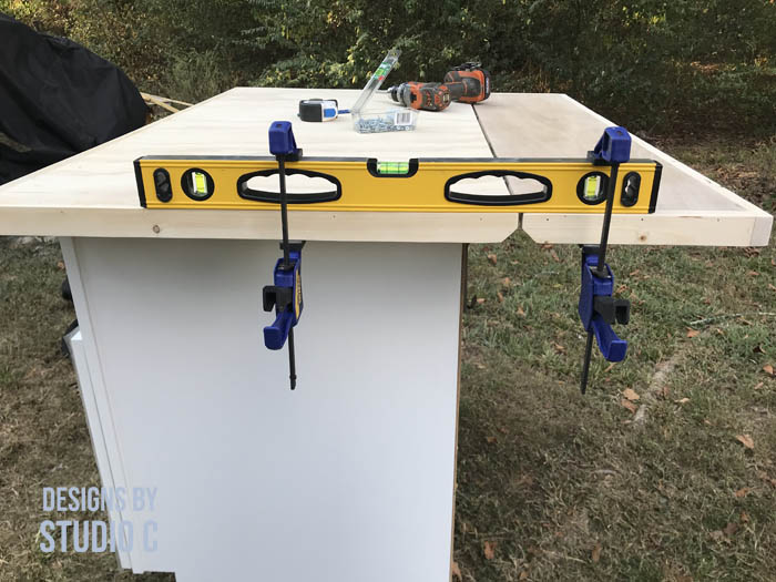 how to make a work table out of a base cabinet a level clamped to top and leaf before installing hardware