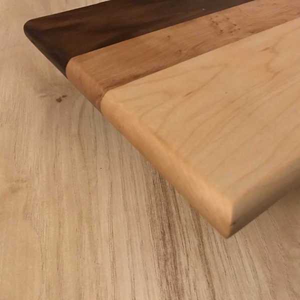 hardwood serving board with oval handle edge view