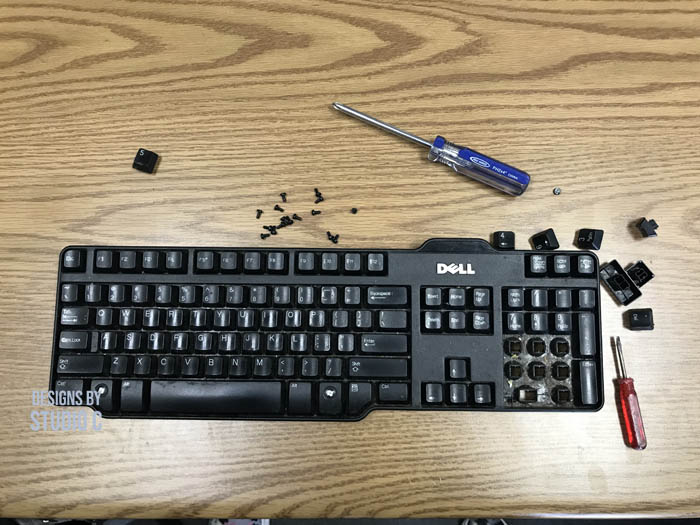 how to clean computer keyboard image with screw drivers and screws