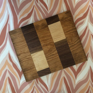 hardwood patchwork cutting serving board on flame background