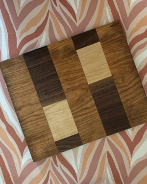 hardwood patchwork cutting serving board on flame background